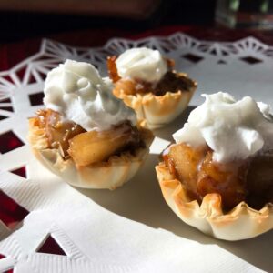 three pear and macadamia bites on a plate.