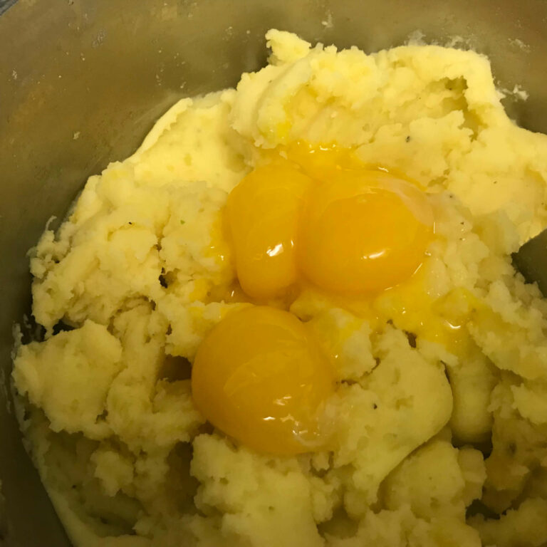 potatoes with eggs in pot.