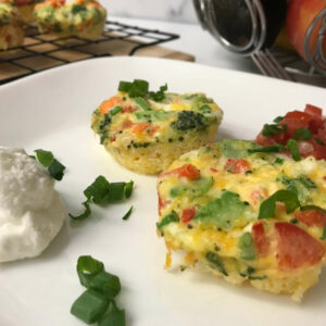 egg muffins on a plate with yogurt and salsa.