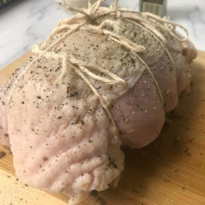 twine wrapped raw turkey breast.