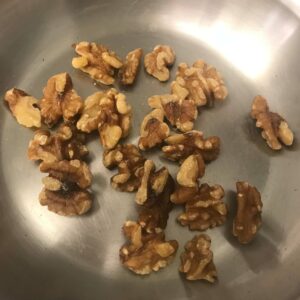 walnuts toasting in a skillet.