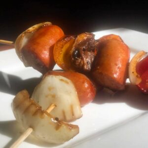 plated glazed smoked bourbon bratwurst skewers.