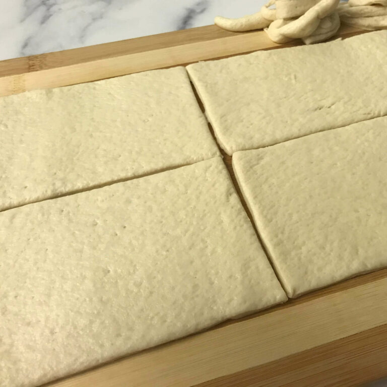 pizza dough cut into four rectangles.