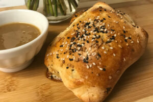 baked calzone with dipping sauce.