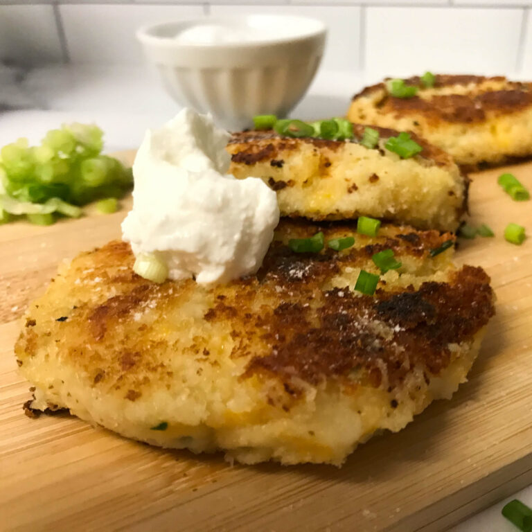 potato cakes topped with yogurt and green onions.