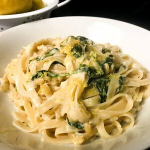 bowl of finished pasta topped with lemon zest.