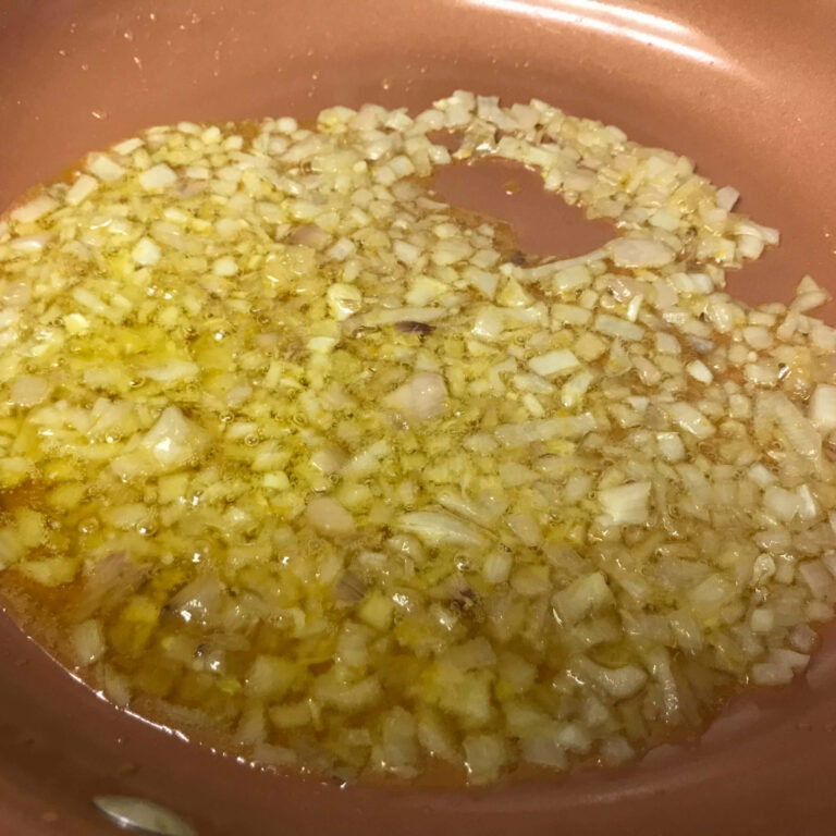onions cooking in skillet.