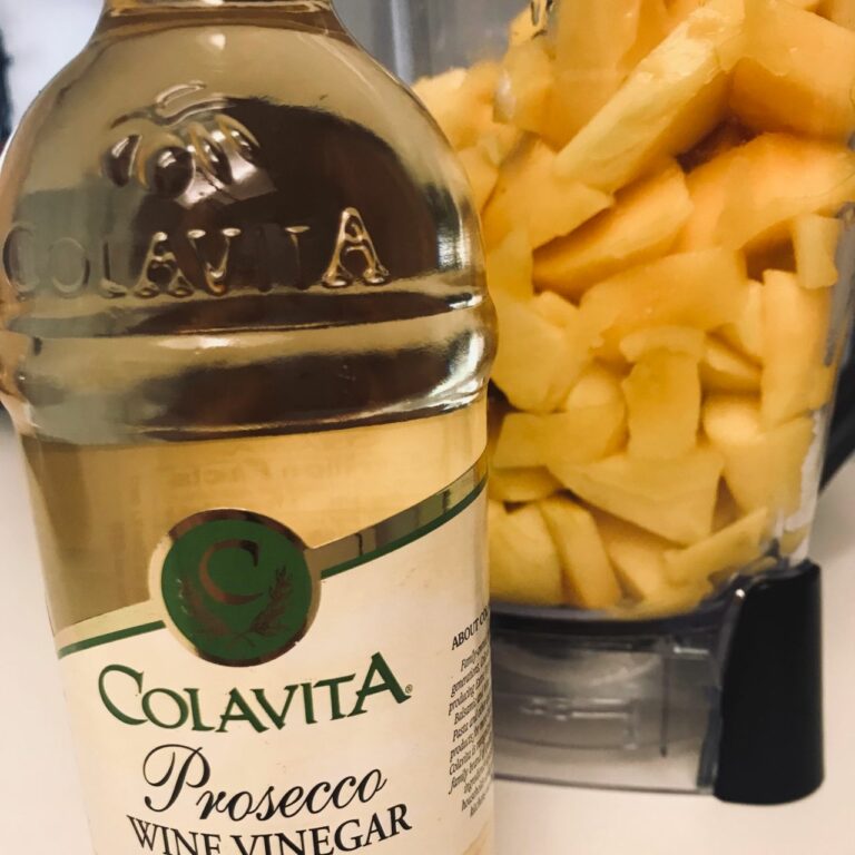 prosecco wine vinegar next to blender with mango