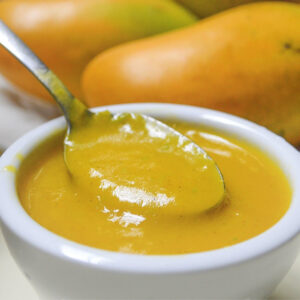 mango dressing in cup with spoon