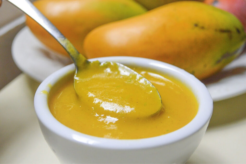 mango sauce in cup with spoon