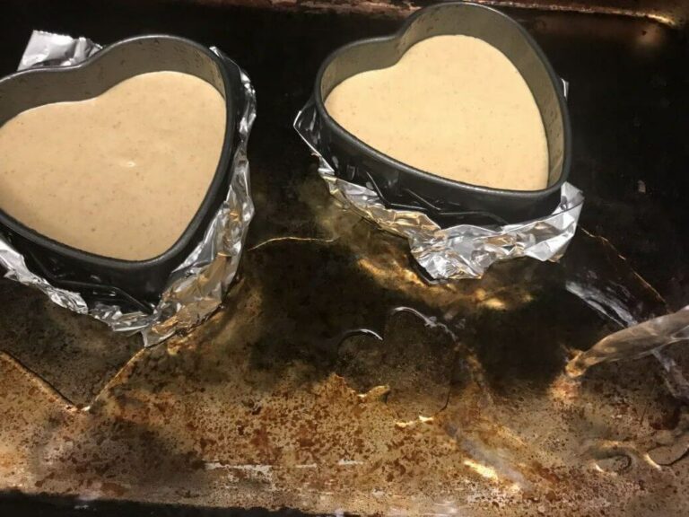 heart shaped pans filled with cheesecake mixture.