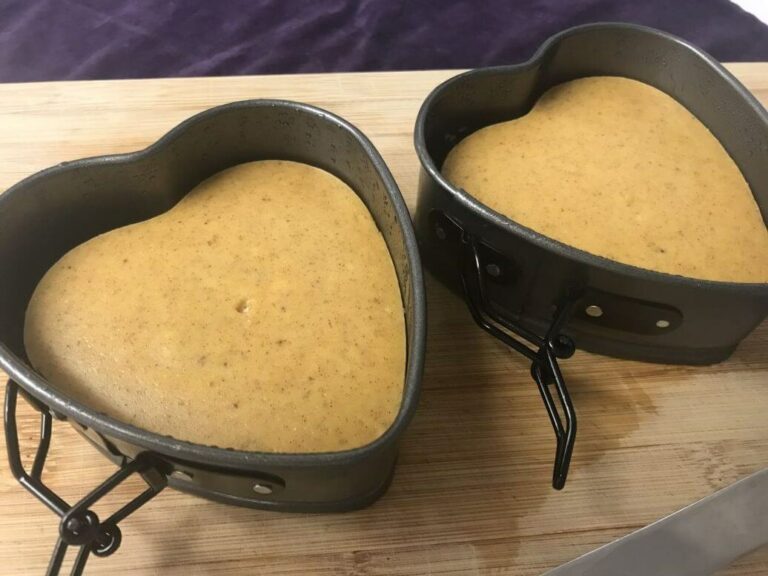 two cooked cheesecakes in heart shaped pans.