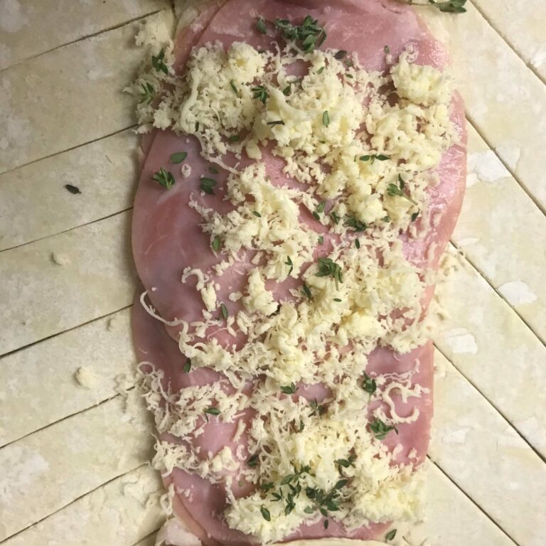 grated gruyere and thyme on ham.
