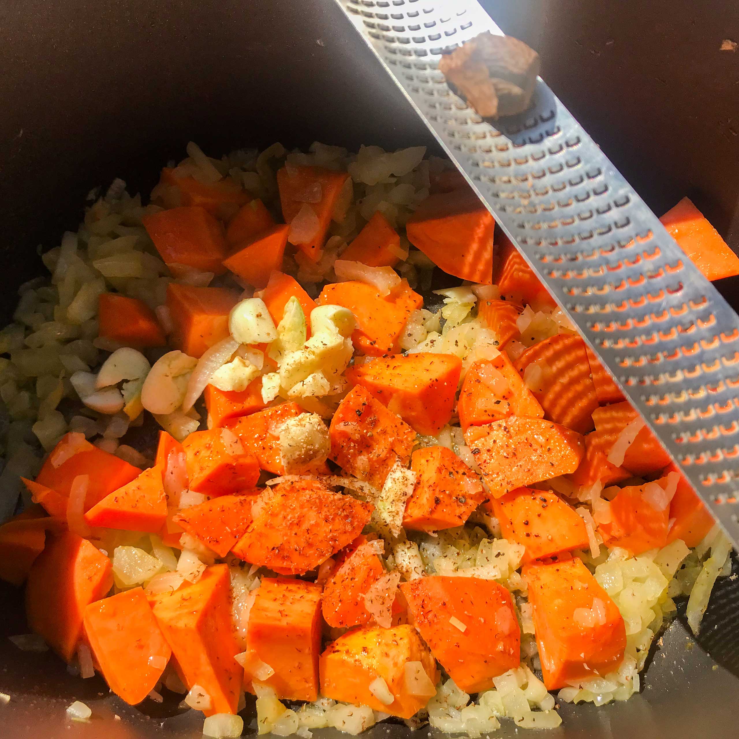 veggies and seasonings in a pot.
