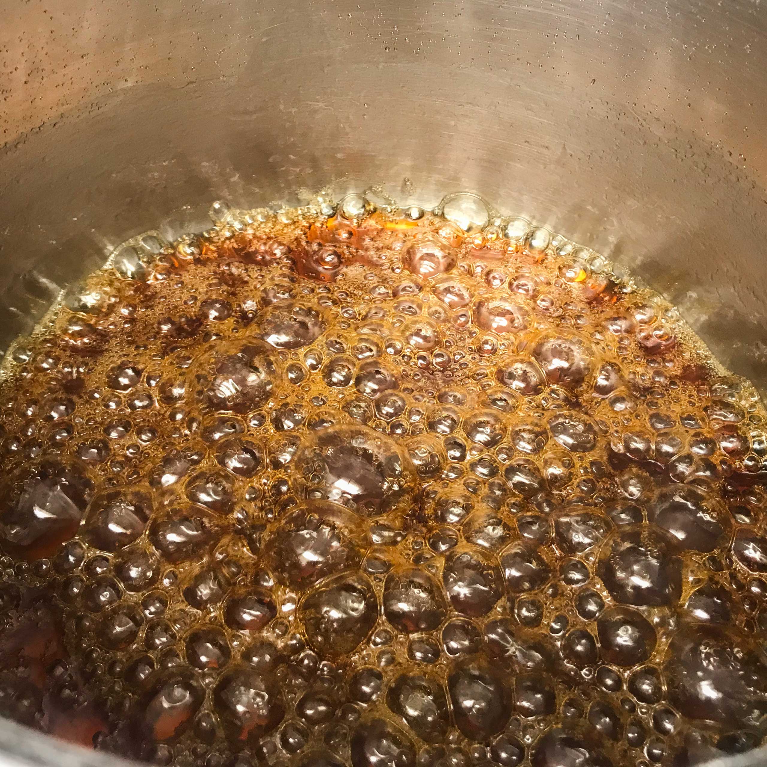 caramel boiling in pot.