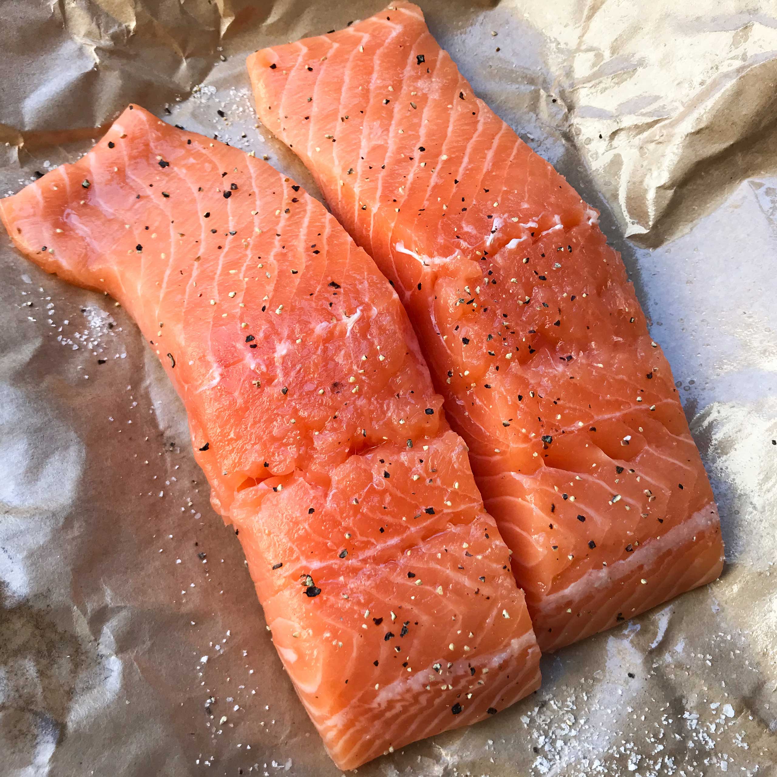 raw salmon fillets with salt and pepper.