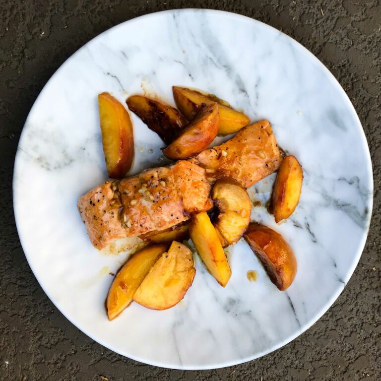 salmon with bourbon and peaches on a plate.