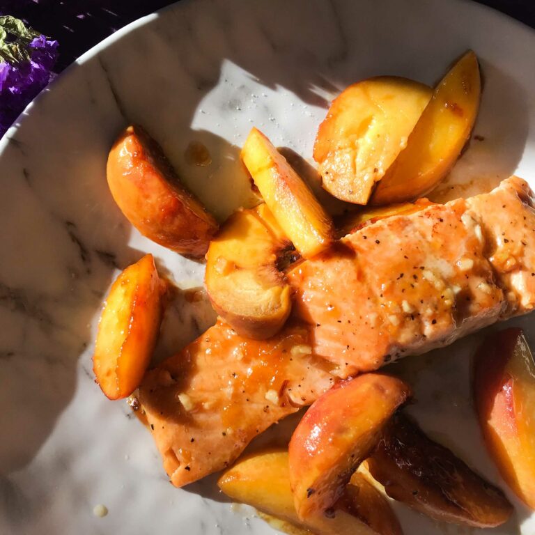 salmon and peaches on a plate.