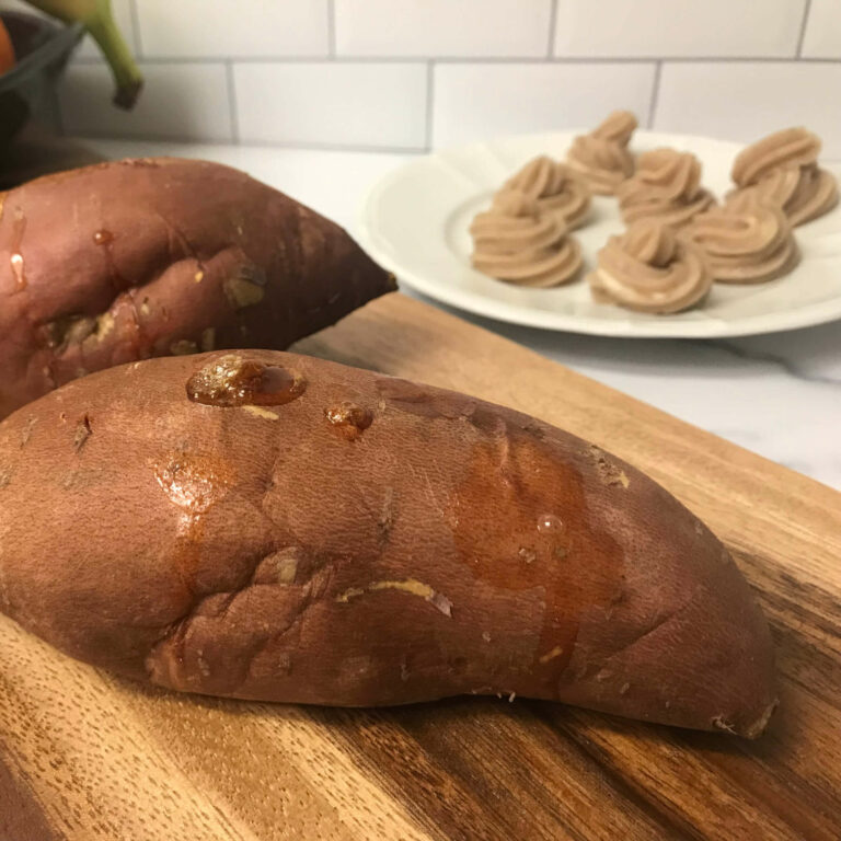 cooked sweet potatoes next to swirls of butter.