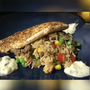 plated tilapia on dirty rice.