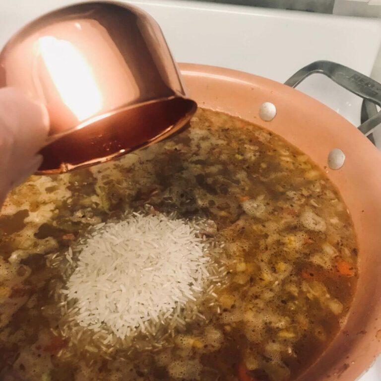 rice being added to skillet.