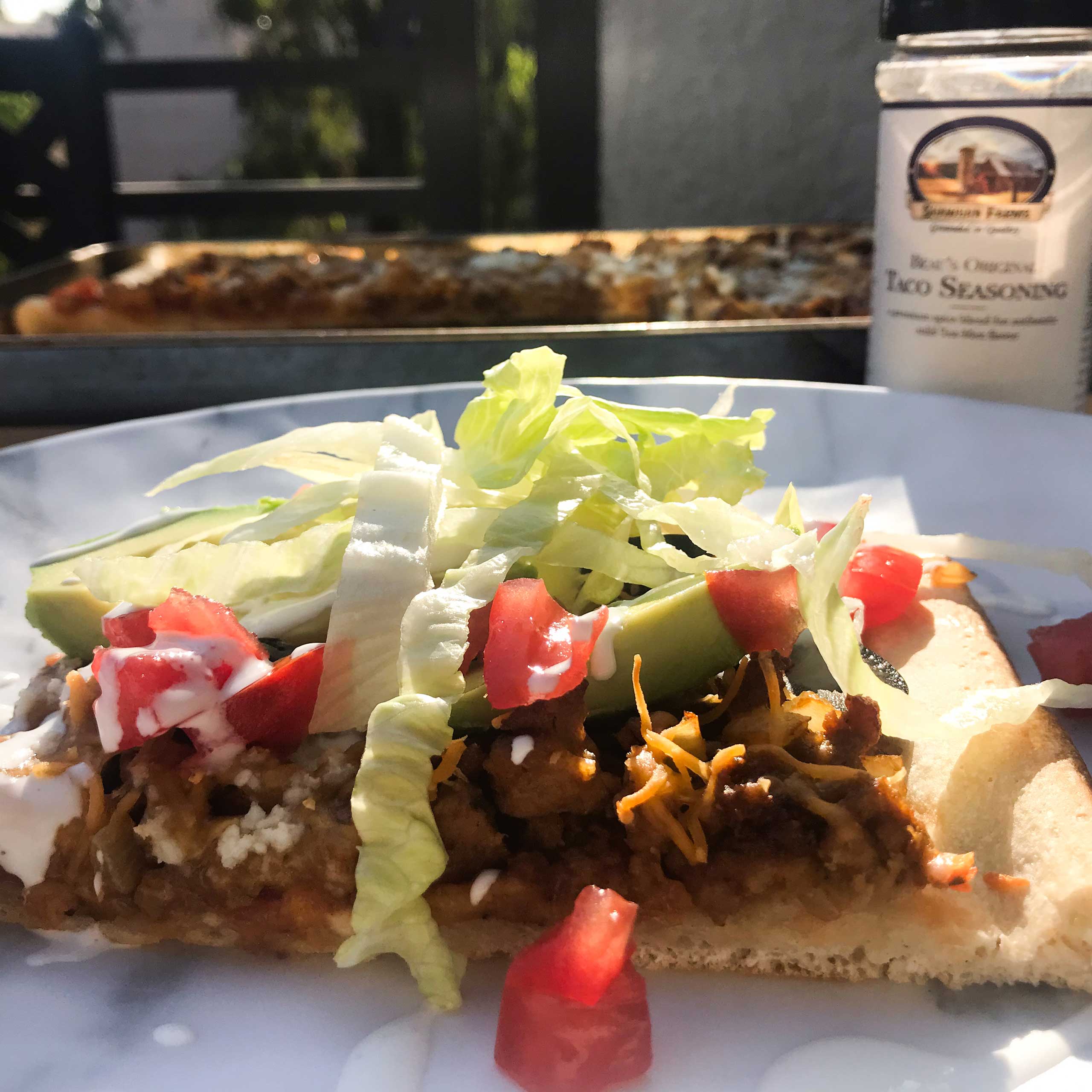 sliced of cooked ground turkey taco pizza with toppings.