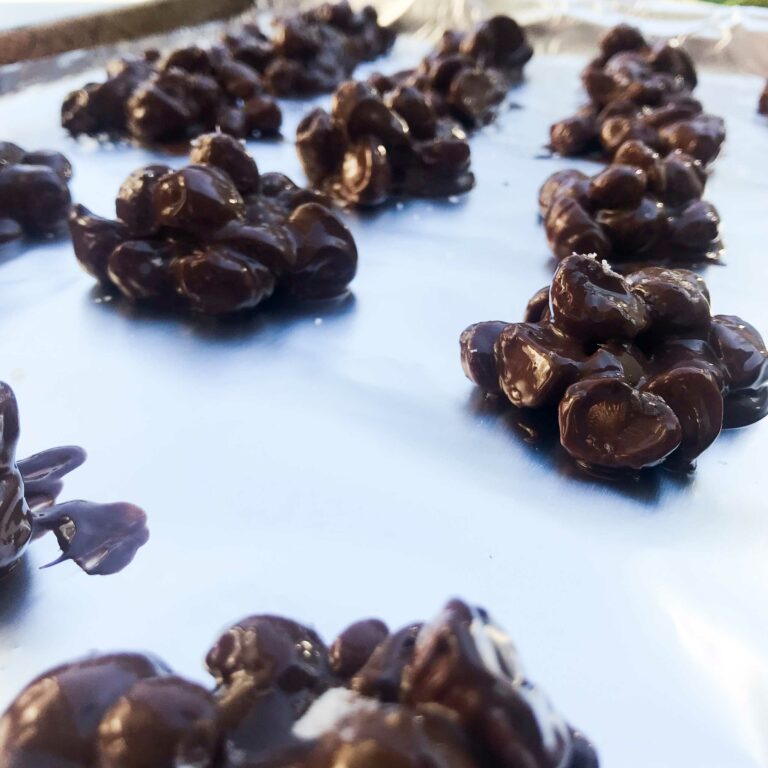 chocolate nut clusters on baking sheet.