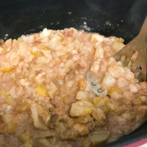 mashing pears in a pot.