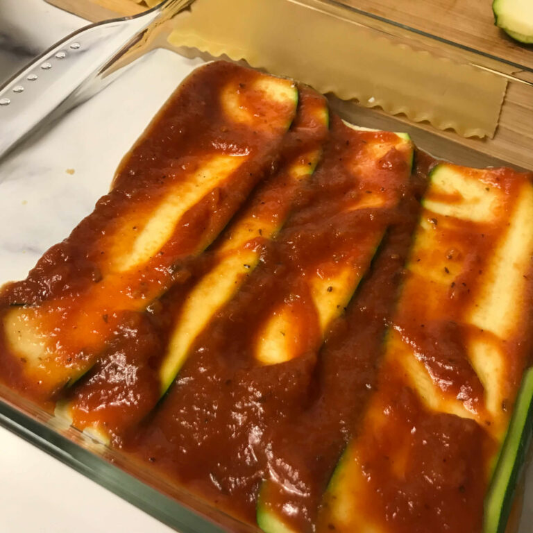sauce on top of zucchini.