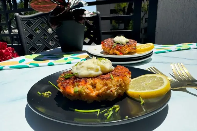 old fashioned salmon patties with tartar sauce on a plate.
