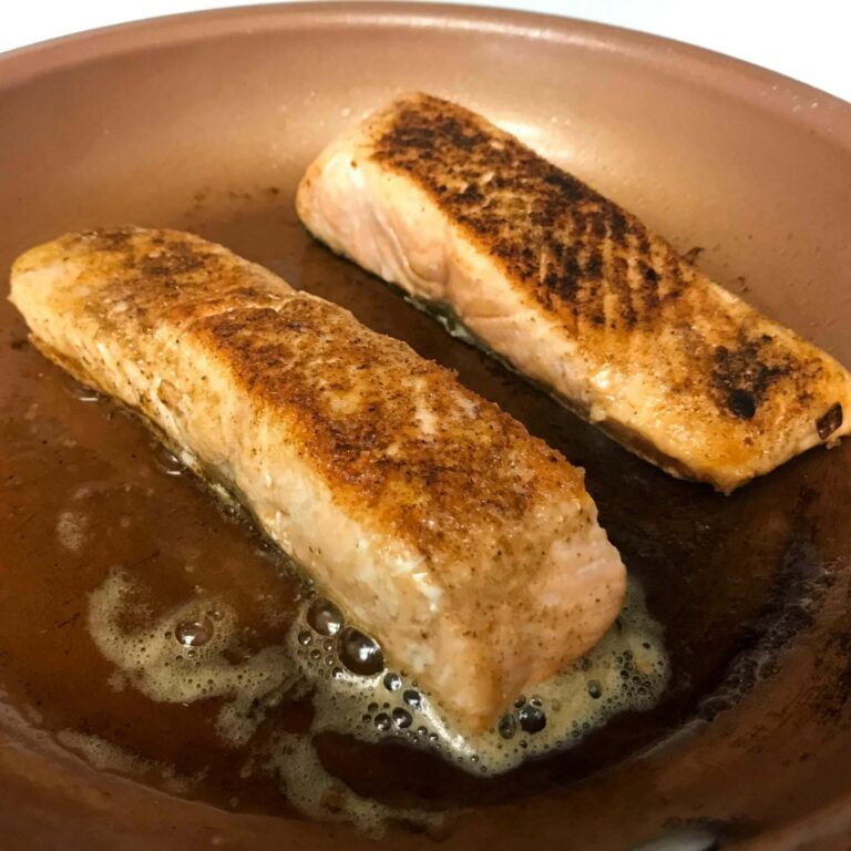 salmon cooking in skillet.