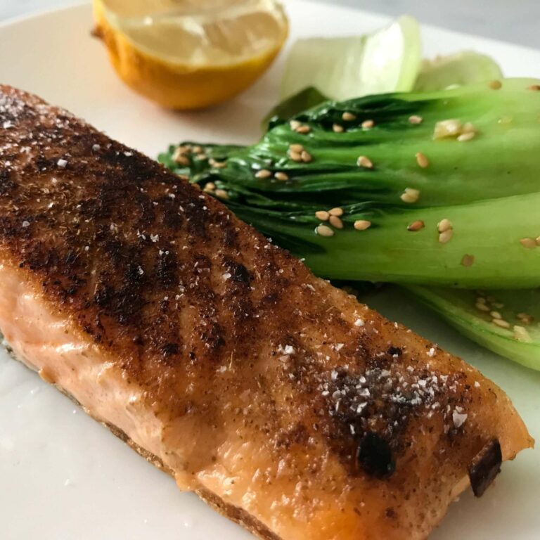 salmon and bok choy on a plate.