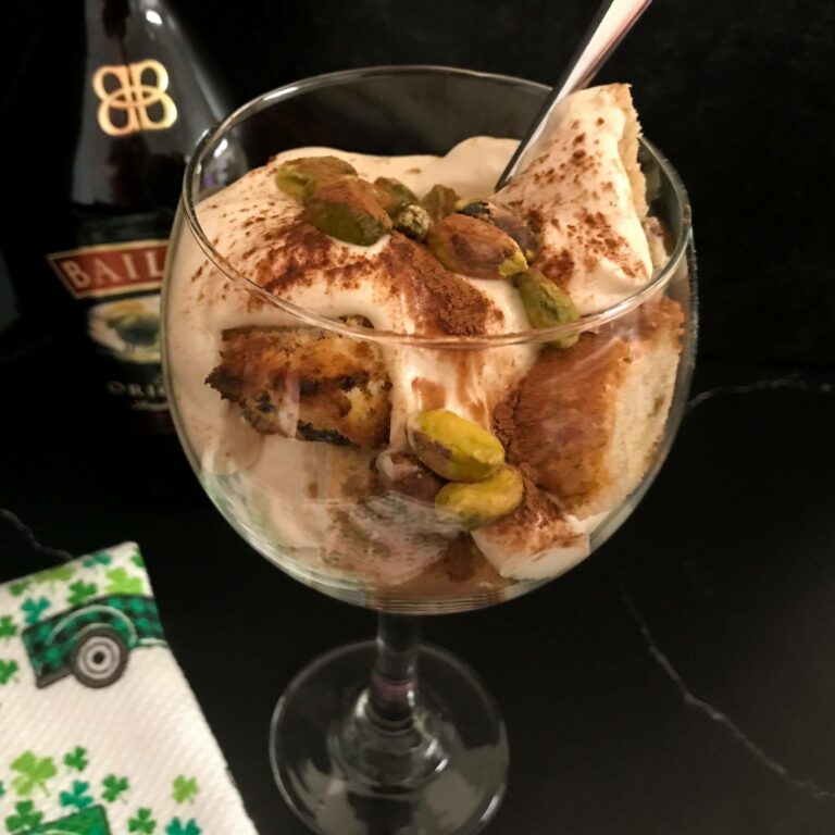 A spoon in the Irish baileys parfait topped with cinnamon and pistachios.
