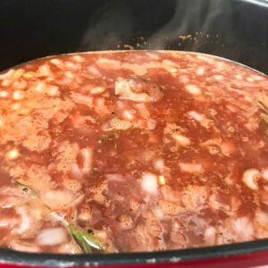 lamb shanks braising in liquid.