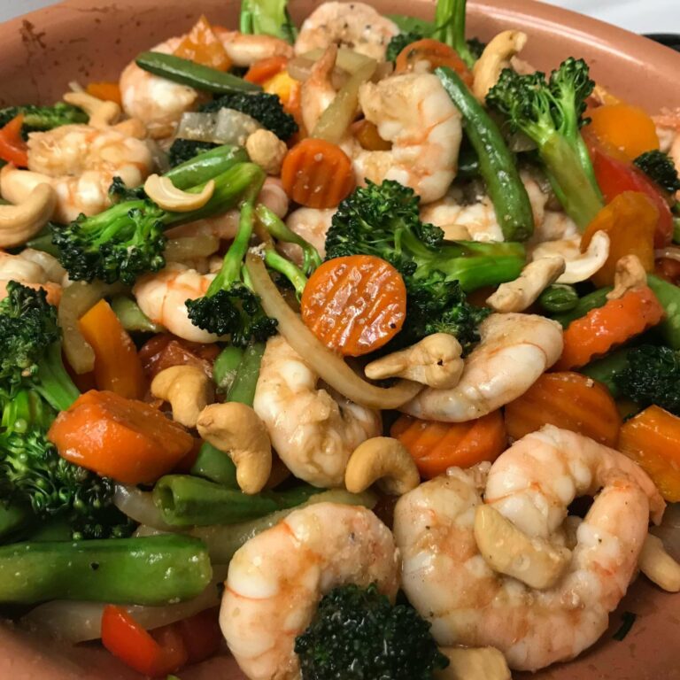 shrimp added to veggies in skillet.
