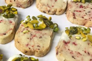 cranberry pistachio shortbread cookies dipped in white chocolate.