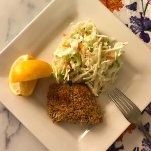 crispy salmon and healthy coleslaw on a plate.