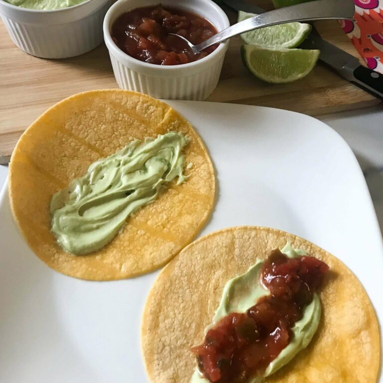 tortillas topped with creama and salsa.