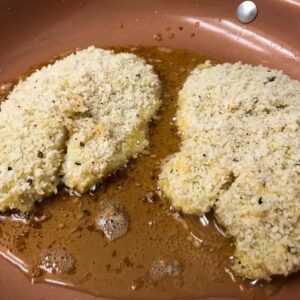 fish frying in skillet.