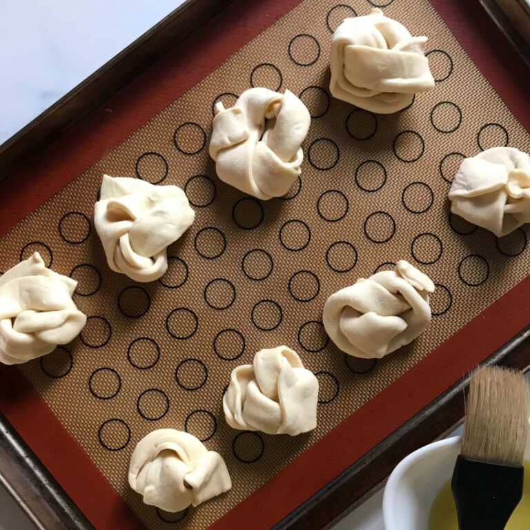 raw Garlic Knots on a baking sheet.