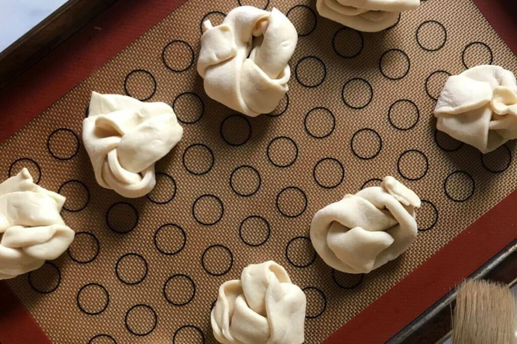 raw Garlic Knots on a baking sheet.