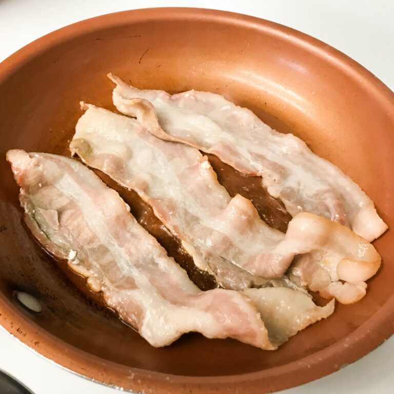 bacon cooking in skillet.