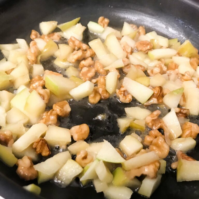 cooked apples and walnuts in skillet.