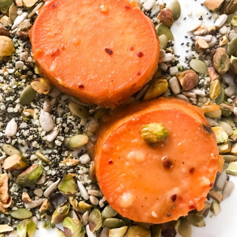 dipping sweet potato rounds in seeds and nuts.