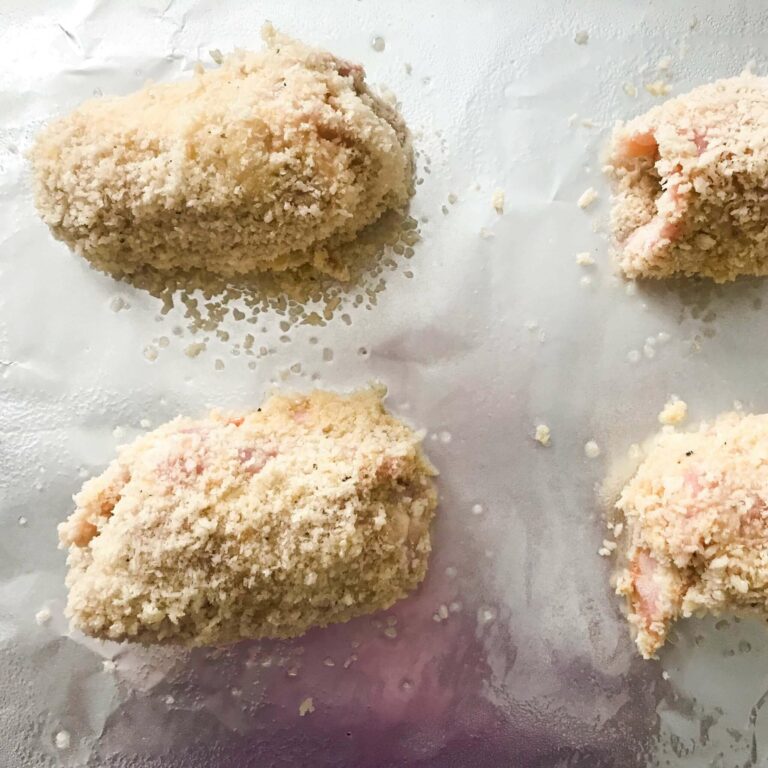 breaded thighs on baking sheet.