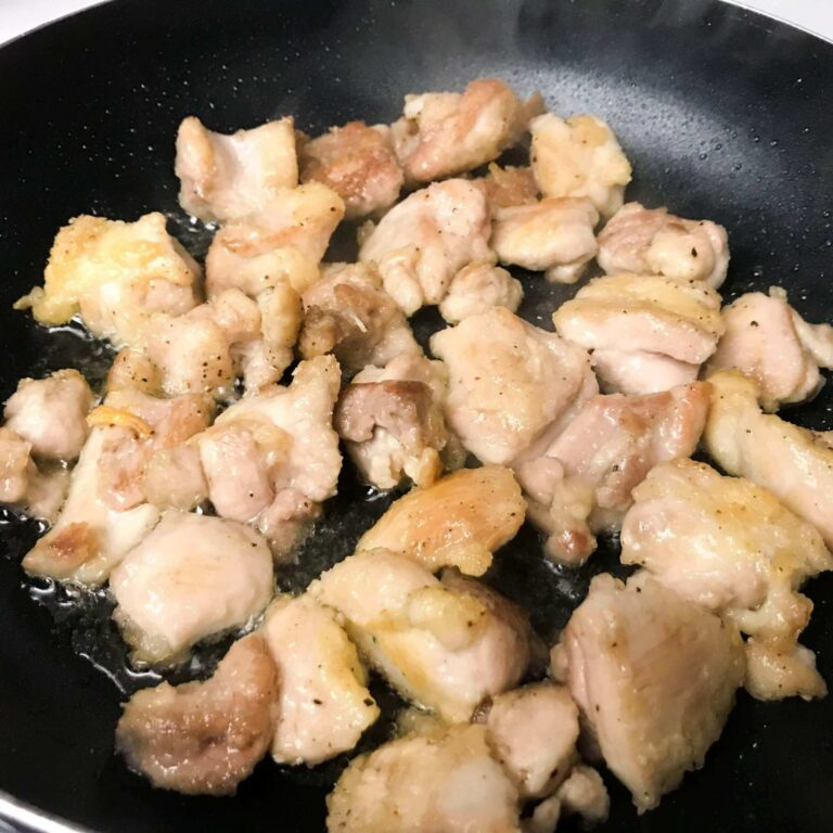 chicken cooking in skillet.