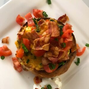 scrambled egg bread bowls topped with bacon.