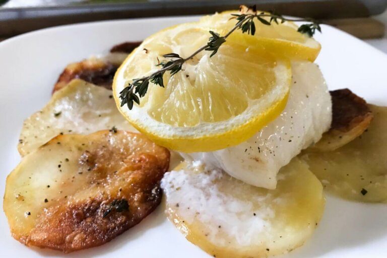 cod and potatoes on a plate.