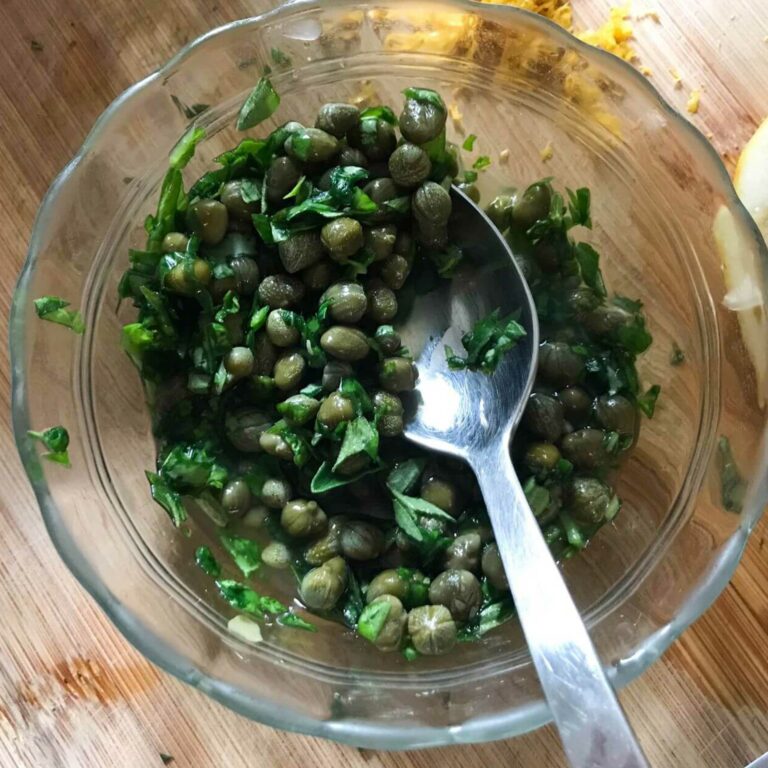 bowl of capers and herbs.