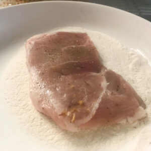 raw pork chops in flour.